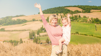 Fototapeta na wymiar Family on holiday in Tuscany, mother and daughter are watching t