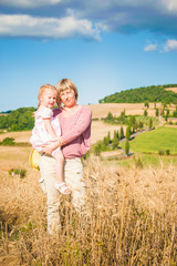Mother and daughter relaxing in Tuscany Landscape, Italy