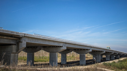 Fototapeta na wymiar Highway bridge with concrete pylons crossing a river - Belgrade,