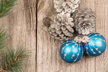 Christmas baubles and pine cones top view