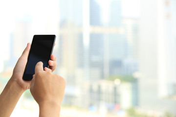 young woman hands use cellphone in city 