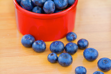 Blueberry in red can on a wooden table