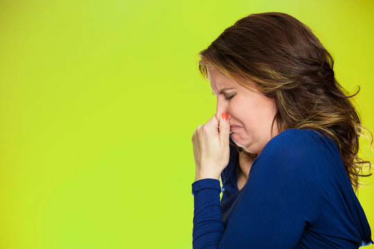 woman covers pinches her nose something stinks