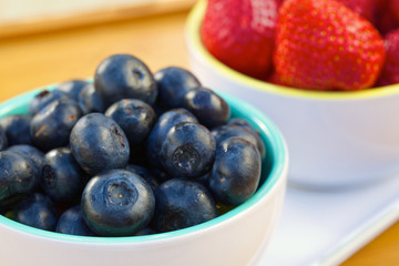 Blueberry and strawberry in white cans
