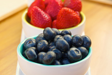 Blueberry and strawberry in white cans