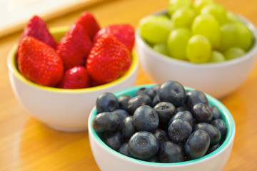 Blueberries, strawberries and grapes in cans