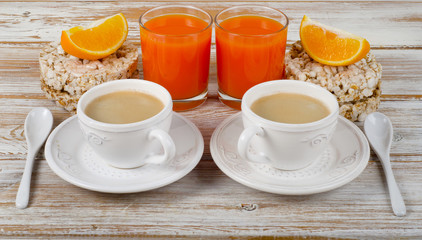 Obraz na płótnie Canvas breakfast with two coffee cup and orange juice