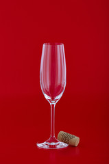 Wine glass with cork over red
