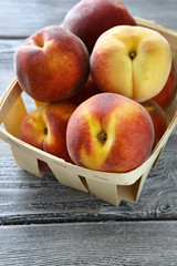 ripe peaches in a wooden crate