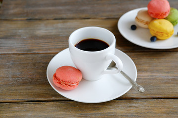 white coffee cup and colorful macaroon