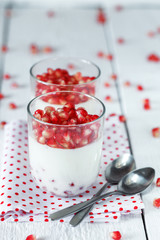 Delicious dessert  pannacotta with fresh pomegranate seeds in a