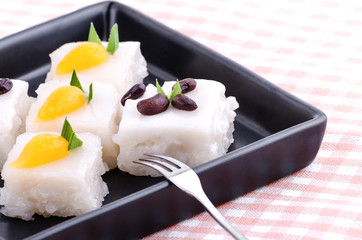 Thai dessert made from glutinous rice and sprinkle with coconut