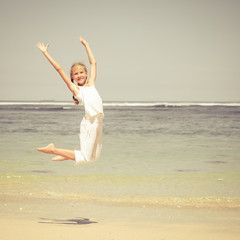 teen girl  jumping on the beach