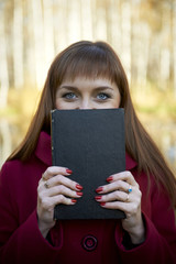 Beautiful young girl with a book