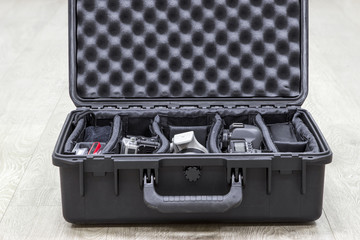 Opened plastic case with photo equipments in dividers