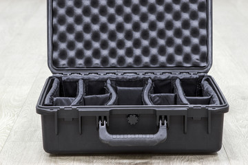 Opened empty plastic case for photo equipments with dividers