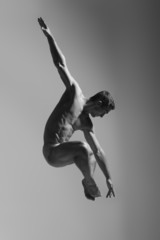 Dance freedom concept. Young handsome ballet man in fly grace po