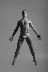 Fototapeta na wymiar Dance freedom concept. Young handsome ballet man in fly grace po