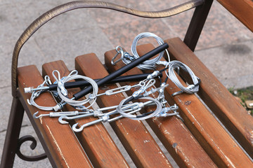 Fototapeta na wymiar Hooks, fastening, rope lying on a wooden bench