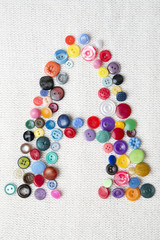 Letter A of the alphabet of buttons of various shapes and colors
