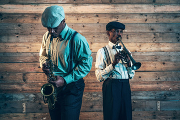 Two african american jazz musicians playing trumpet and saxophon