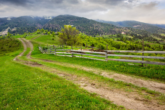 fence on hillside meadow in mountain