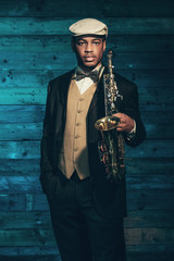 Vintage african american jazz musician with saxophone in front o