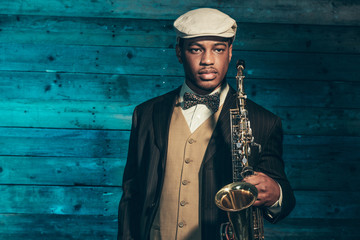 Vintage african american jazz musician with saxophone in front o