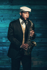 Vintage african american jazz musician with saxophone in front o