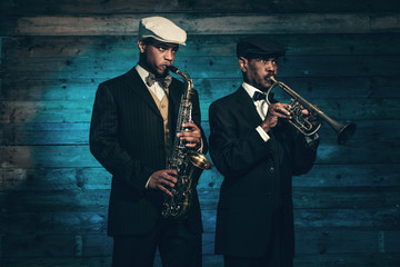 Two vintage african american jazz musicians with trumpet and sax
