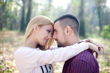 Fototapeta premium Young couple in autumn park