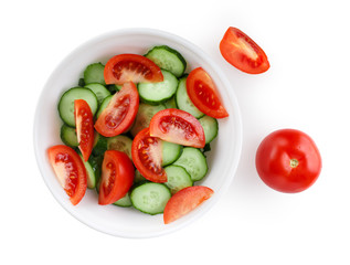 Sliced tomatoes and cucumbers on a white plate