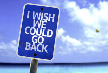 I Wish We Could Go Back sign with a beach on background