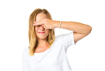 Pretty woman covering her eyes over isolated white background