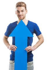 Young man holding a blue arrow