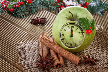 Fototapeta na wymiar Christmas clock in an apple with winter decoration