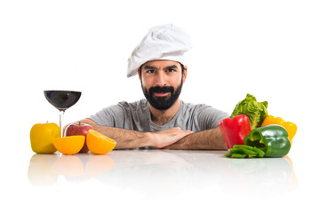 Chef with several vegetables and fruits on table