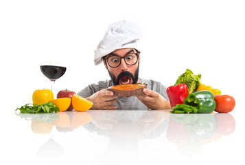 Crazy hipster chef with several vegetables and fruits
