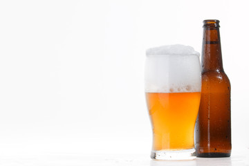 Beer bottle and glass with cold beer