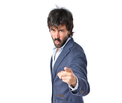 Angry man pointing somebody over isolated white background