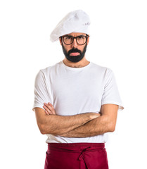 Sad chef over white background