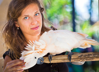 Woman in zoo with parrot © petunyia