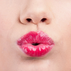 Close up of womans pouting lips with red lipstick
