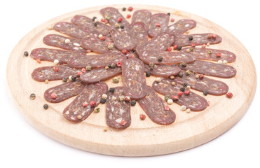 flat sausage on rounder wooden board isolated