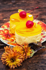 dessert with quince jelly decorated with cherry and saucer