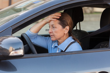 frightened mature woman in   car.