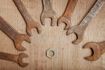 rusty wrenches on a wooden background 4