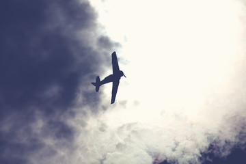 Fighter plane on cloudy sky
