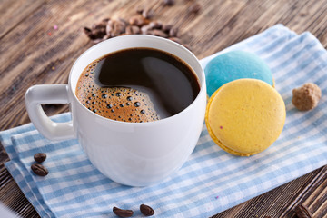 Cup of coffee and french macaron.