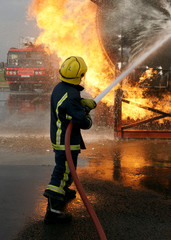 fire fighter fighting blaze